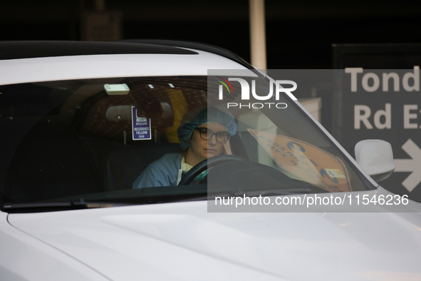 A hospital employee waits in their car for pro-Palestine demonstrators to pass during a protest at Georgetown University in Washington, D.C....