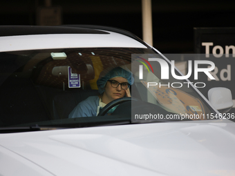 A hospital employee waits in their car for pro-Palestine demonstrators to pass during a protest at Georgetown University in Washington, D.C....