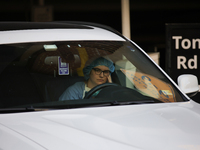 A hospital employee waits in their car for pro-Palestine demonstrators to pass during a protest at Georgetown University in Washington, D.C....