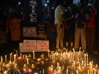 People participate in a protest to condemn the brutal rape and murder of a trainee doctor at RG Kar Medical College and Hospital in Kolkata,...