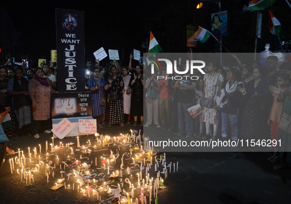 People participate in a protest to condemn the brutal rape and murder of a trainee doctor at RG Kar Medical College and Hospital in Kolkata,...