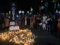 People participate in a protest to condemn the brutal rape and murder of a trainee doctor at RG Kar Medical College and Hospital in Kolkata,...