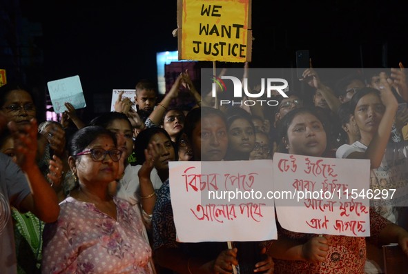 People participate in a protest to condemn the brutal rape and murder of a trainee doctor at RG Kar Medical College and Hospital in Kolkata,...