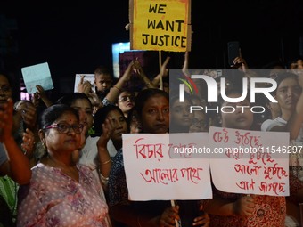 People participate in a protest to condemn the brutal rape and murder of a trainee doctor at RG Kar Medical College and Hospital in Kolkata,...