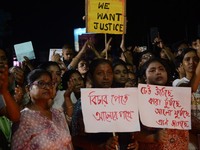 People participate in a protest to condemn the brutal rape and murder of a trainee doctor at RG Kar Medical College and Hospital in Kolkata,...