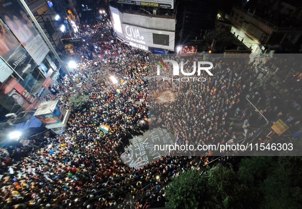 People participate in a protest to condemn the brutal rape and murder of a trainee doctor at RG Kar Medical College and Hospital in Kolkata,...