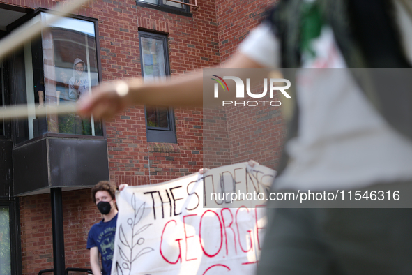 Students watch from windows as pro-Palestine demonstrators protest at Georgetown University in Washington, D.C. on September 4, 2024. 