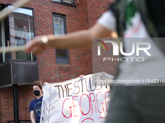 Students watch from windows as pro-Palestine demonstrators protest at Georgetown University in Washington, D.C. on September 4, 2024. (