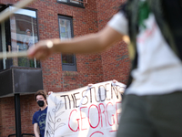 Students watch from windows as pro-Palestine demonstrators protest at Georgetown University in Washington, D.C. on September 4, 2024. (