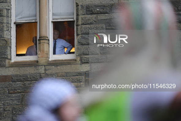 Faculty watch from windows as pro-Palestine demonstrators protest on the steps of Healy Hall at Georgetown University in Washington, D.C. on...