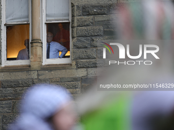 Faculty watch from windows as pro-Palestine demonstrators protest on the steps of Healy Hall at Georgetown University in Washington, D.C. on...