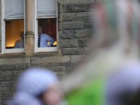 Faculty watch from windows as pro-Palestine demonstrators protest on the steps of Healy Hall at Georgetown University in Washington, D.C. on...