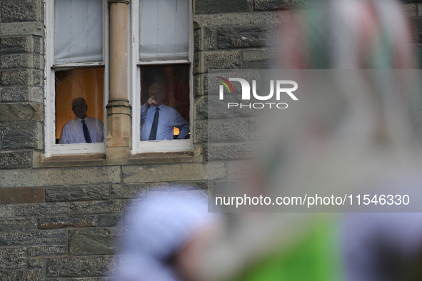 Faculty watch from windows as pro-Palestine demonstrators protest on the steps of Healy Hall at Georgetown University in Washington, D.C. on...