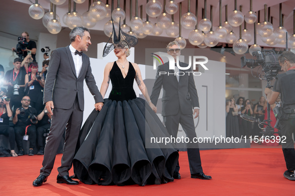 Joaquin Phoenix, Lady Gaga, and Director Todd Phillips attend the ''Joker: Folie a Deux'' red carpet during the 81st Venice International Fi...