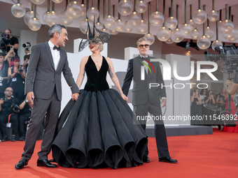 Joaquin Phoenix, Lady Gaga, and Director Todd Phillips attend the ''Joker: Folie a Deux'' red carpet during the 81st Venice International Fi...