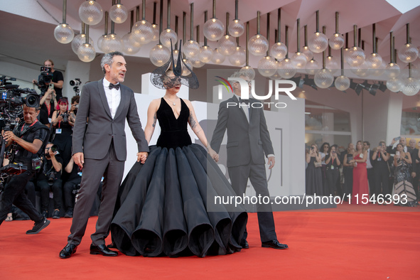 Joaquin Phoenix, Lady Gaga, and Director Todd Phillips attend the ''Joker: Folie a Deux'' red carpet during the 81st Venice International Fi...