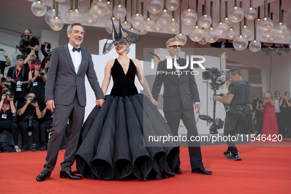 Joaquin Phoenix, Lady Gaga, and Director Todd Phillips attend the ''Joker: Folie a Deux'' red carpet during the 81st Venice International Fi...