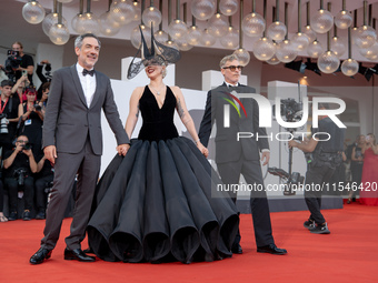 Joaquin Phoenix, Lady Gaga, and Director Todd Phillips attend the ''Joker: Folie a Deux'' red carpet during the 81st Venice International Fi...