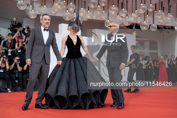 Joaquin Phoenix, Lady Gaga, and Director Todd Phillips attend the ''Joker: Folie a Deux'' red carpet during the 81st Venice International Fi...