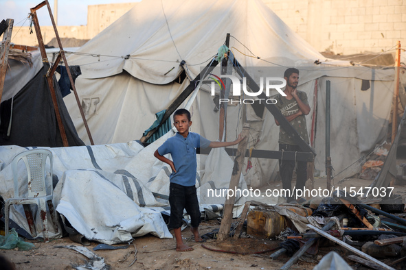 Palestinians inspect the site of an Israeli strike on tents for displaced people inside Al-Aqsa Martyrs Hospital amid the Israel-Hamas confl...