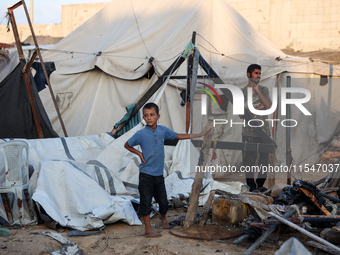 Palestinians inspect the site of an Israeli strike on tents for displaced people inside Al-Aqsa Martyrs Hospital amid the Israel-Hamas confl...