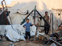 Palestinians inspect the site of an Israeli strike on tents for displaced people inside Al-Aqsa Martyrs Hospital amid the Israel-Hamas confl...