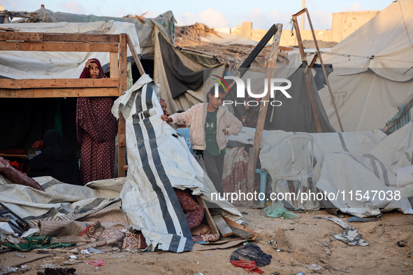 Palestinians inspect the site of an Israeli strike on tents for displaced people inside Al-Aqsa Martyrs Hospital amid the Israel-Hamas confl...