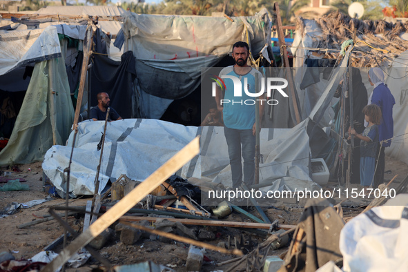 Palestinians inspect the site of an Israeli strike on tents for displaced people inside Al-Aqsa Martyrs Hospital amid the Israel-Hamas confl...