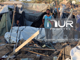 Palestinians inspect the site of an Israeli strike on tents for displaced people inside Al-Aqsa Martyrs Hospital amid the Israel-Hamas confl...