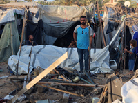 Palestinians inspect the site of an Israeli strike on tents for displaced people inside Al-Aqsa Martyrs Hospital amid the Israel-Hamas confl...