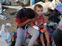 Palestinians inspect the site of an Israeli strike on tents for displaced people inside Al-Aqsa Martyrs Hospital amid the Israel-Hamas confl...