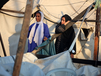 Palestinians inspect the site of an Israeli strike on tents for displaced people inside Al-Aqsa Martyrs Hospital amid the Israel-Hamas confl...