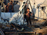 Palestinians inspect the site of an Israeli strike on tents for displaced people inside Al-Aqsa Martyrs Hospital amid the Israel-Hamas confl...