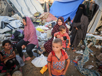 Palestinians inspect the site of an Israeli strike on tents for displaced people inside Al-Aqsa Martyrs Hospital amid the Israel-Hamas confl...