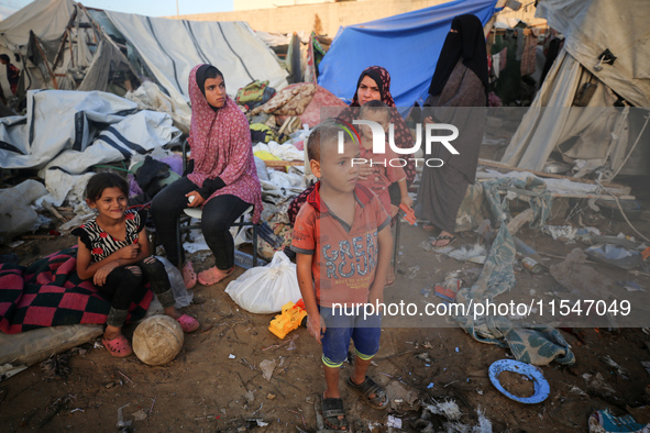 Palestinians inspect the site of an Israeli strike on tents for displaced people inside Al-Aqsa Martyrs Hospital amid the Israel-Hamas confl...