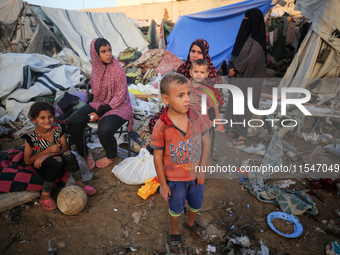 Palestinians inspect the site of an Israeli strike on tents for displaced people inside Al-Aqsa Martyrs Hospital amid the Israel-Hamas confl...