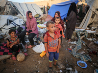 Palestinians inspect the site of an Israeli strike on tents for displaced people inside Al-Aqsa Martyrs Hospital amid the Israel-Hamas confl...