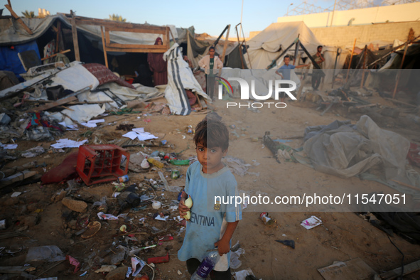 Palestinians inspect the site of an Israeli strike on tents for displaced people inside Al-Aqsa Martyrs Hospital amid the Israel-Hamas confl...