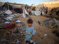 Palestinians inspect the site of an Israeli strike on tents for displaced people inside Al-Aqsa Martyrs Hospital amid the Israel-Hamas confl...