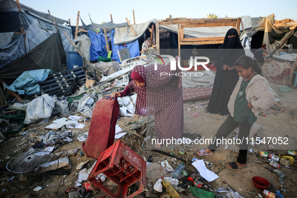 Palestinians inspect the site of an Israeli strike on tents for displaced people inside Al-Aqsa Martyrs Hospital amid the Israel-Hamas confl...