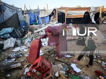 Palestinians inspect the site of an Israeli strike on tents for displaced people inside Al-Aqsa Martyrs Hospital amid the Israel-Hamas confl...