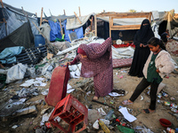 Palestinians inspect the site of an Israeli strike on tents for displaced people inside Al-Aqsa Martyrs Hospital amid the Israel-Hamas confl...