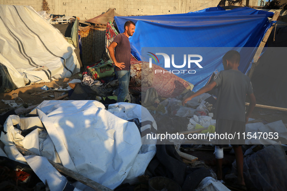 Palestinians inspect the site of an Israeli strike on tents for displaced people inside Al-Aqsa Martyrs Hospital amid the Israel-Hamas confl...