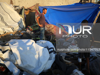 Palestinians inspect the site of an Israeli strike on tents for displaced people inside Al-Aqsa Martyrs Hospital amid the Israel-Hamas confl...