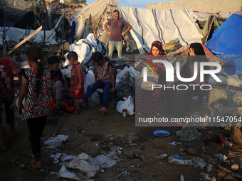 Palestinians inspect the site of an Israeli strike on tents for displaced people inside Al-Aqsa Martyrs Hospital amid the Israel-Hamas confl...