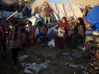 Palestinians inspect the site of an Israeli strike on tents for displaced people inside Al-Aqsa Martyrs Hospital amid the Israel-Hamas confl...