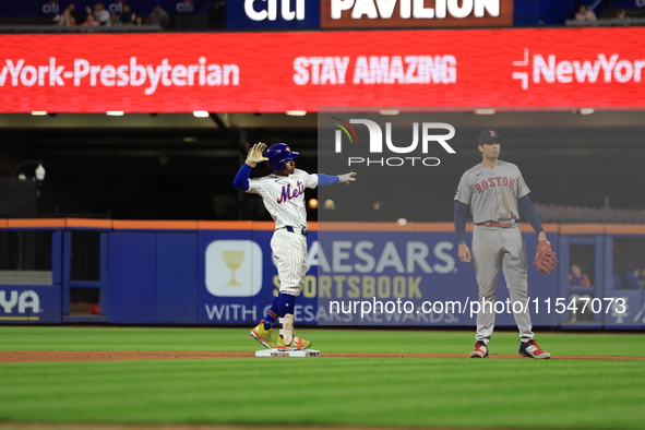 Francisco Lindor #12 of the New York Mets doubles during the fifth inning of the baseball game against the Boston Red Sox at Citi Field in C...