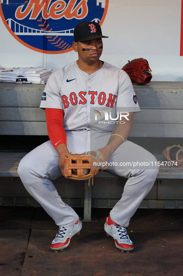 Boston Red Sox Rafael Devers #11 sits in the dugout before the baseball game against the New York Mets at Citi Field in Corona, N.Y., on Sep...