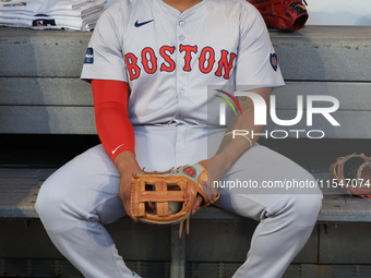 Boston Red Sox Rafael Devers #11 sits in the dugout before the baseball game against the New York Mets at Citi Field in Corona, N.Y., on Sep...