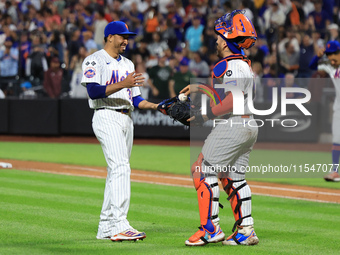 New York Mets relief pitcher Edwin Diaz #39 and catcher Francisco Alvarez #4 celebrate the Mets' 8-3 win in the baseball game against the Bo...